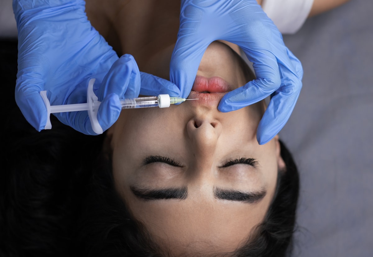 Anti-wrinkle injection procedure with gloved professional, fine syringe, clinical setting